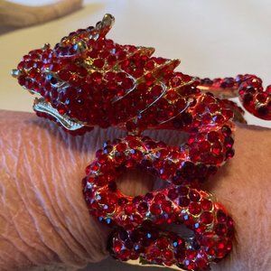 Striking large red jewel encrusted and gold tone dragon clamper bracelet